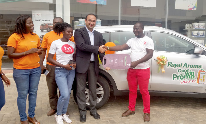 Mr Pankaj Goyal (in suit), Business Head for Rice Imports at Olam Ghana, presents a dummy key to Moses Okpoti, winner of the Royal Aroma grand prize. Looking on are the fiancée of the winner with the actual car keys and Mrs Christina Asare, Royal Aroma Brand Manager 